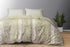A king size bed sheet set with pillow covers featuring a floral pattern, displayed on a bed with a gray wall in the background and a potted plant beside it.